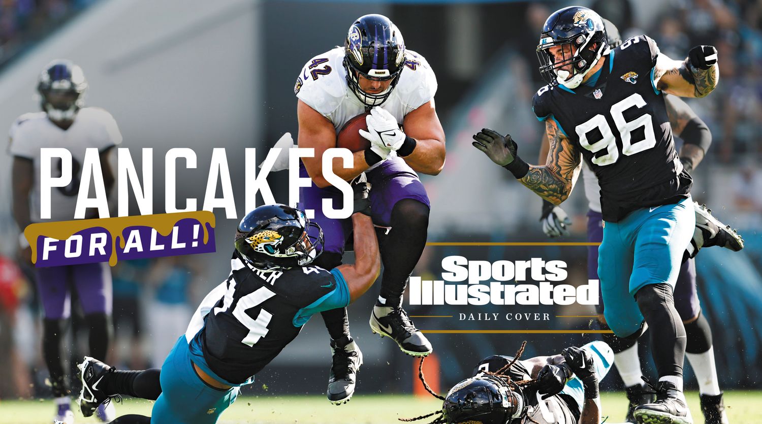 Pat Ricard leaps as he runs through the Jaguars defense